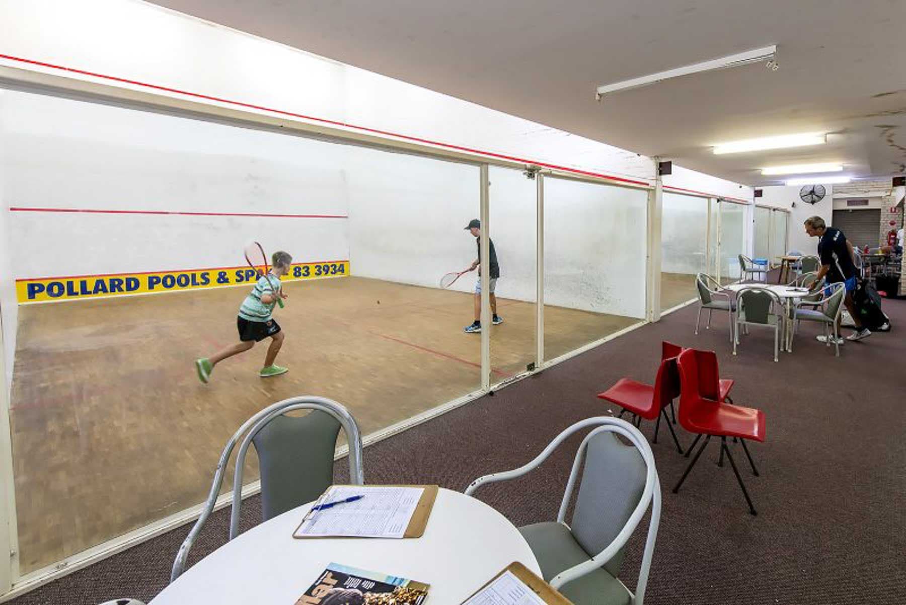 Women playing squash on court