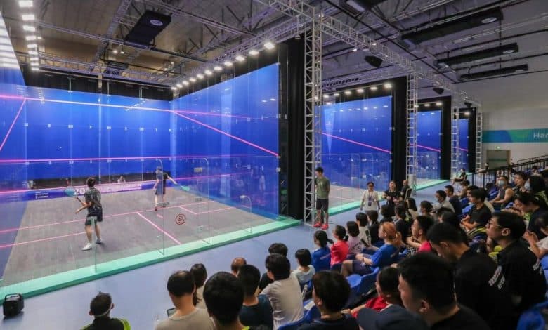 Professional glass squash court with spectators